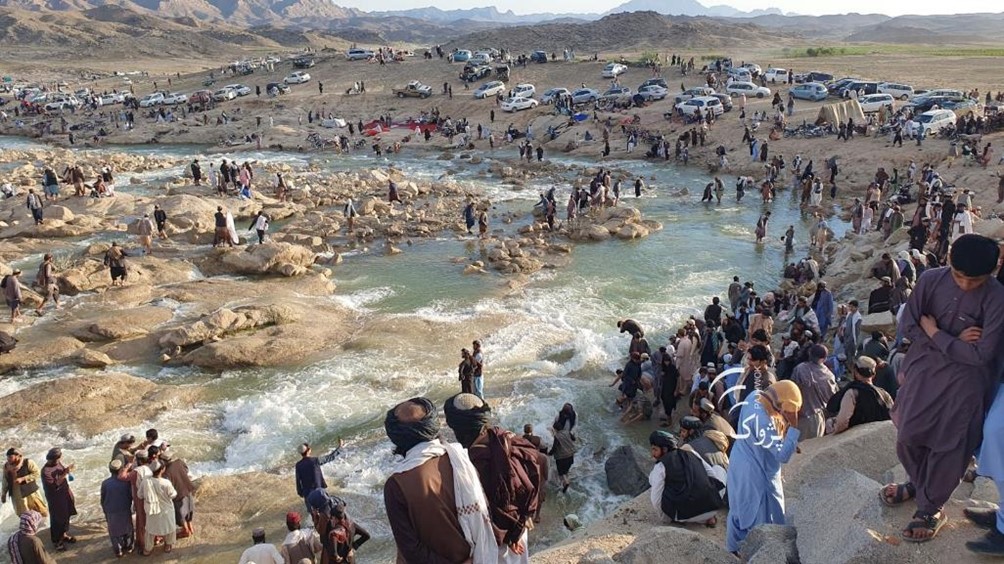 Tourists enjoy excess waterflow from the dam released to the local river in Kandahar province. Photo taken from social media/PAN