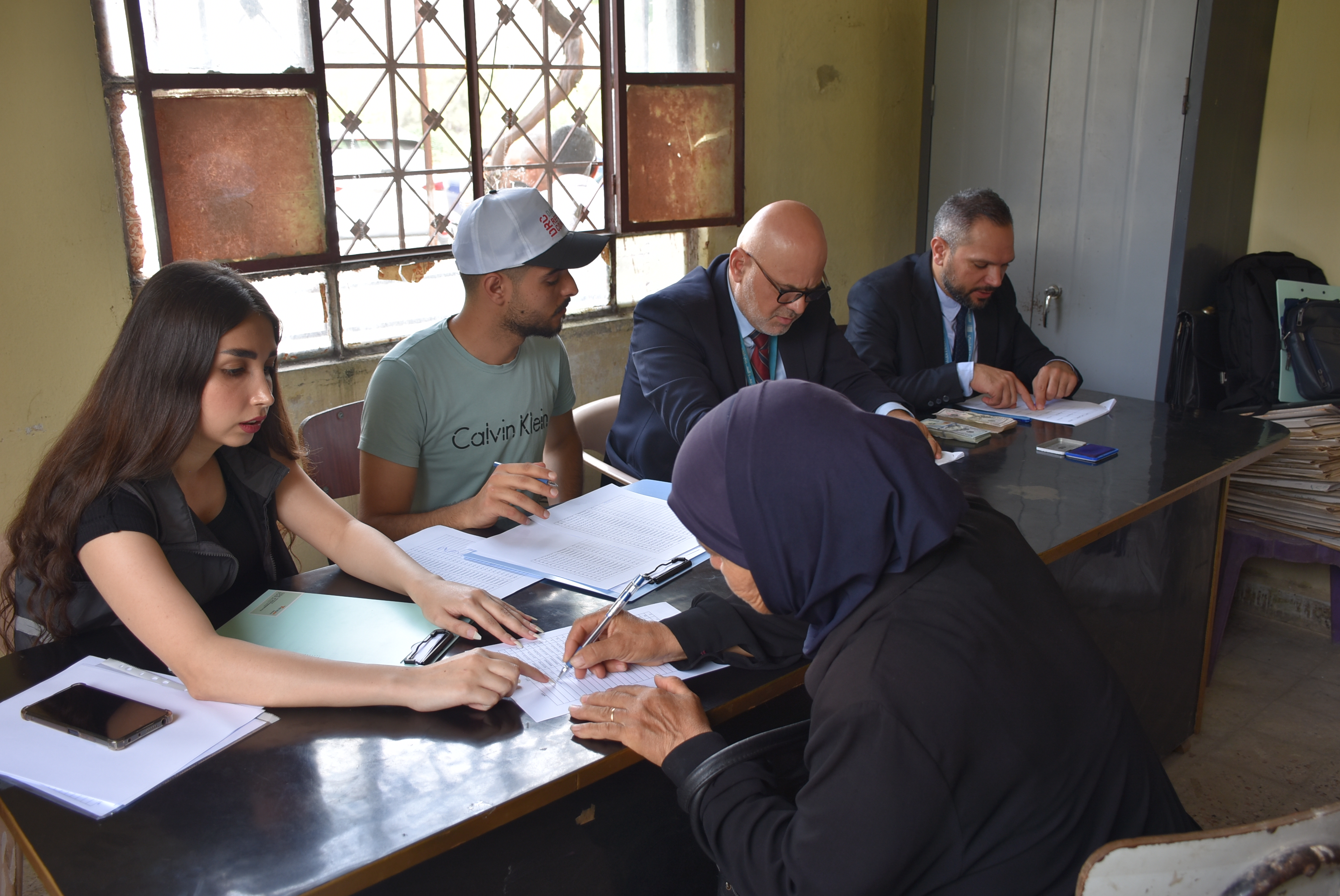 A woman from Balloran receives cash assistance. 